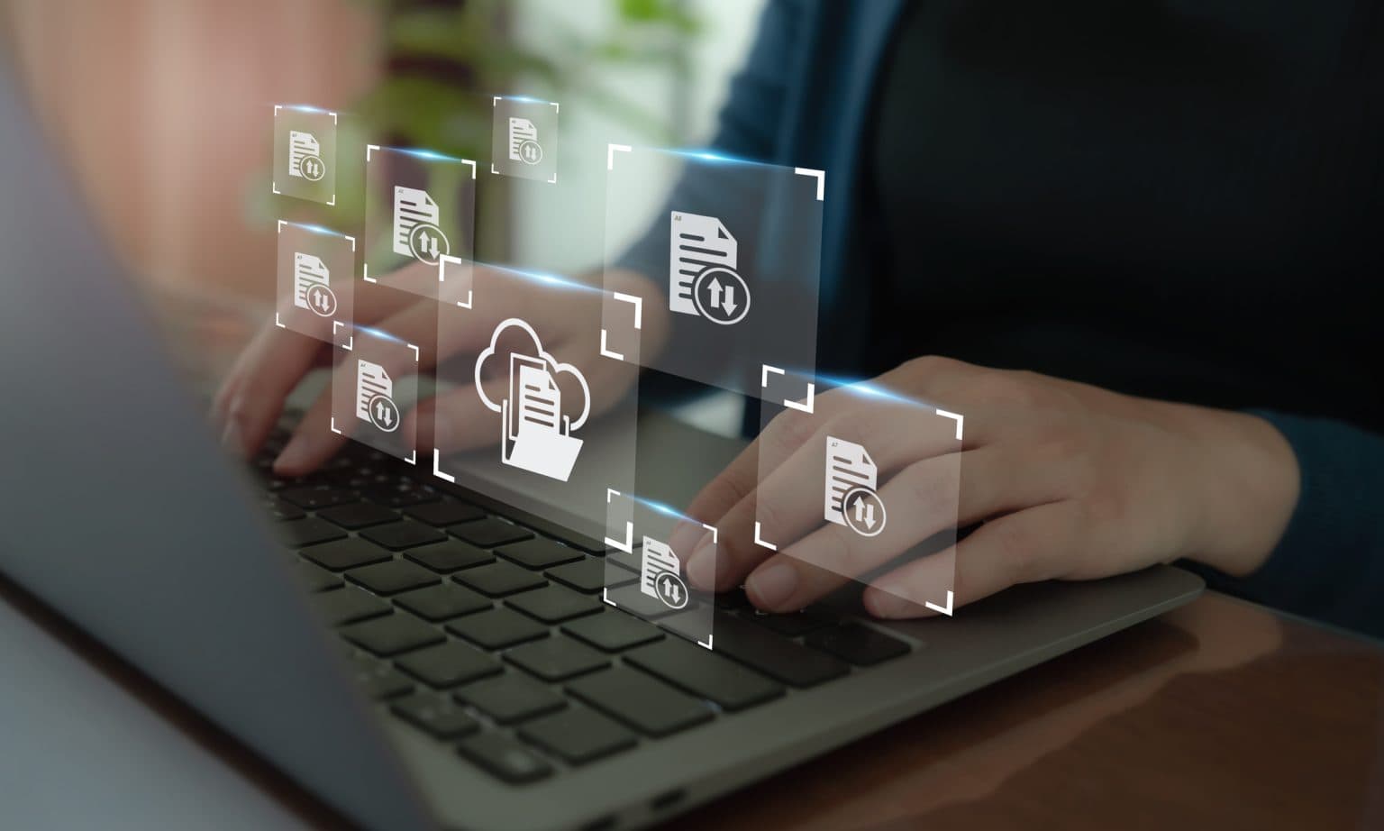 graphic representation of a CMS, file types shown floating about laptop keyboard.